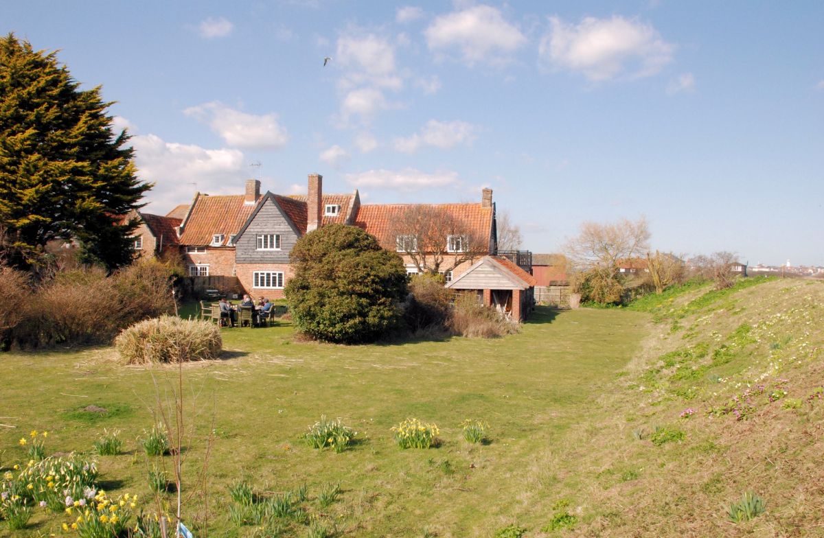 Valley Farm with cart lodge and sea wall, and Southwold and lighthouse in distance